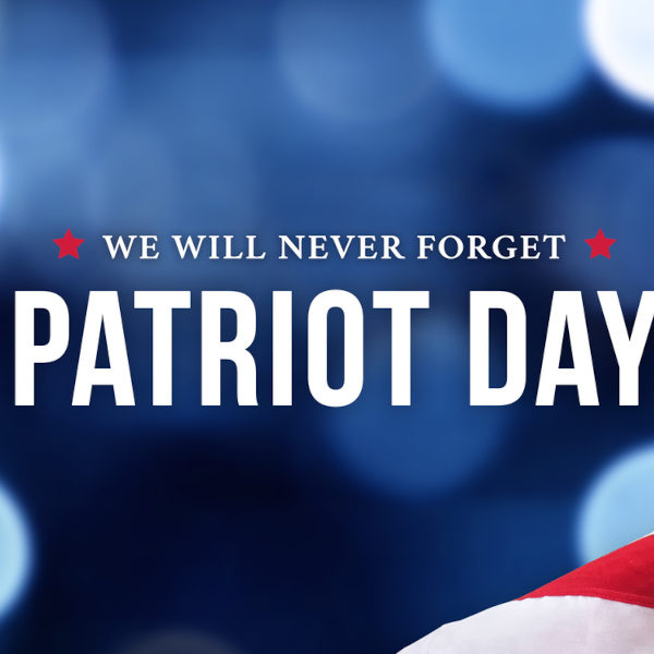 Patriot Day - We Will Never Forget Text Over Blue Bokeh Lights Texture Background and American Flags, 9/11 Remembrance Graphic Design, September 11 Memorial Holiday Banner